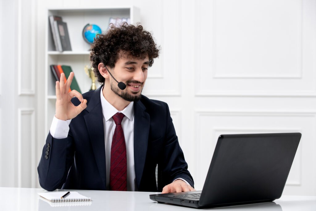 customer-service-handsome-young-guy-office-suit-with-laptop-headset-showing-ok-gesture